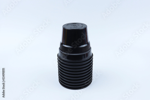 Stack of black plastic cups isolated on white background