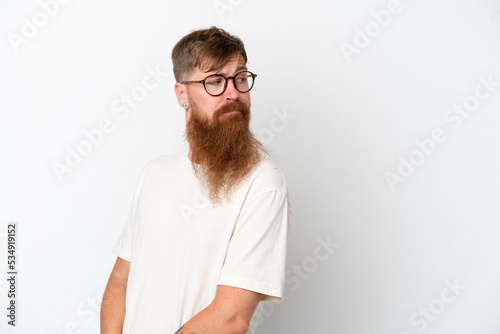 Redhead man with long beard isolated on white background . Portrait © luismolinero