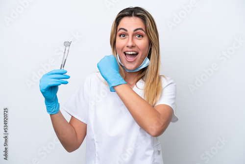 Dentist woman holding tools isolated on white background celebrating a victory