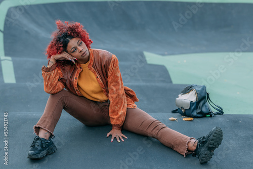urban free-style hipster girl in the park sitting