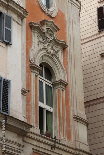 Building Facade Detail with Sculpted Window Ornaments in Rome, Italy