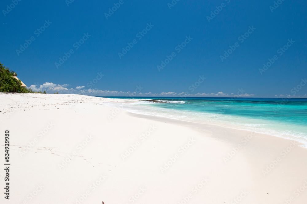 beach with white sand and blue sky