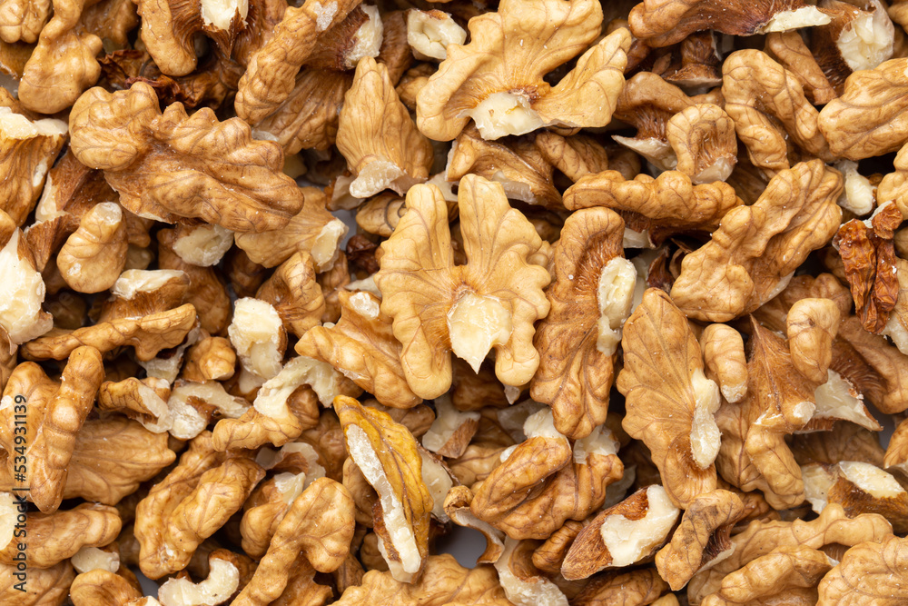 Closeup of big shelled walnuts pile. Nuts are a source of vegetable protein. Closeup of big shelled walnuts pile. Nuts are a source of vegetable protein.