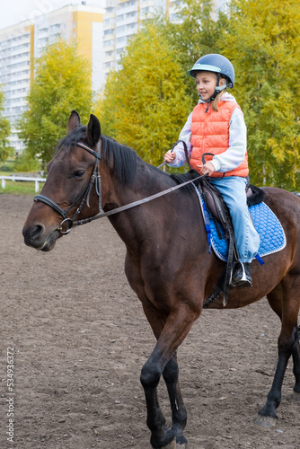 girl learning to ride a horse