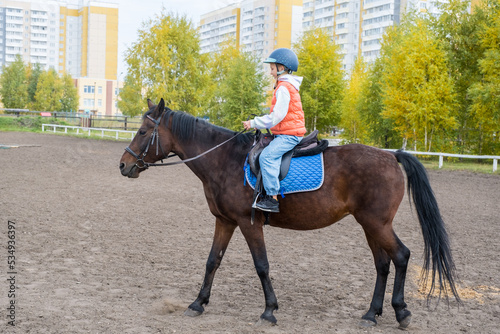 girl learning to ride a horse © Irina