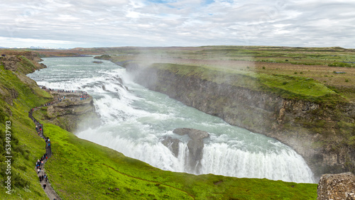 a big crowd in front of the Gulfoss waterfall in  Haukadalur  Iceland