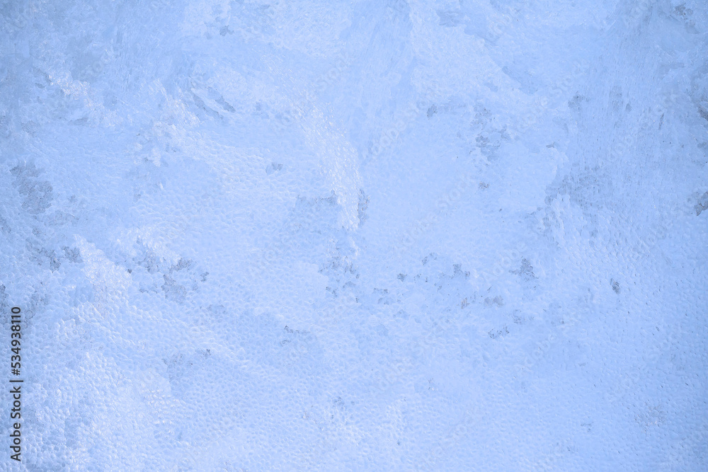 Obraz premium Christmas background. Ice on the window, frosty pattern on the glass.