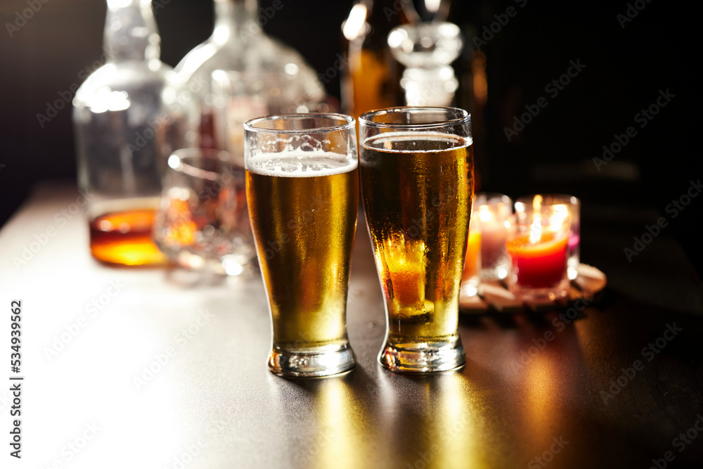 Glass of cold beer on the table in the party at night Glass of cold beer on the table in the party at night