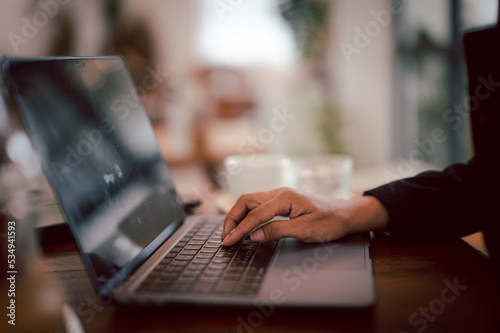 Businesswoman typing on laptop. Woman working at home office hand on keyboard