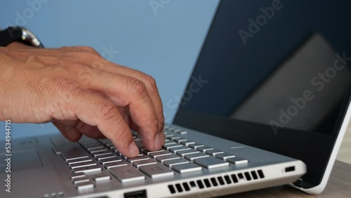 Slow motion hands of business man professional user worker using typing on laptop notebook keyboard on home office desk working online with pc software apps technology concept, close up side view.