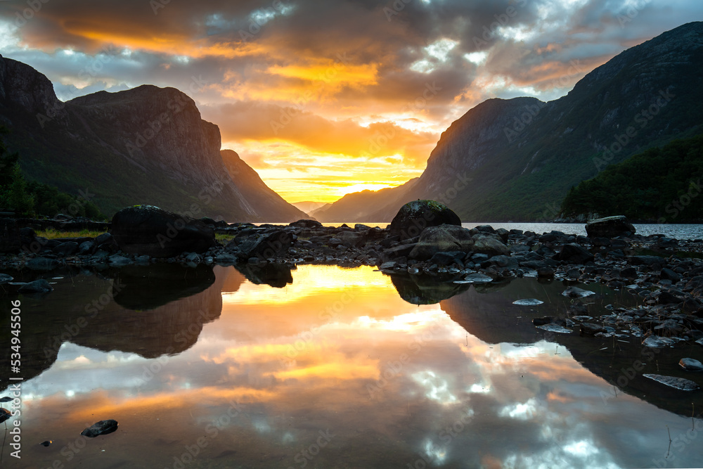 Colourful sunrise over lake and hills