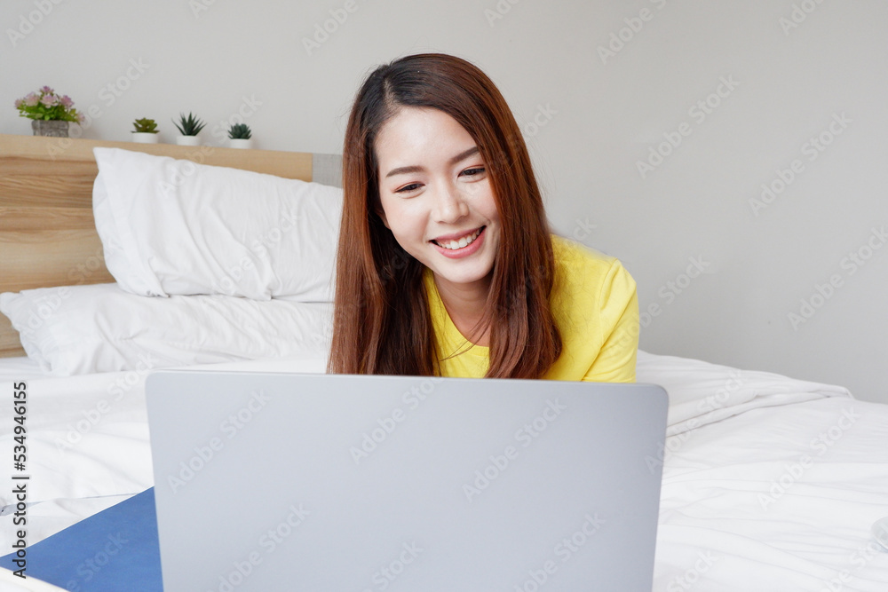 beautiful woman sitting on the couch working on a laptop happy smile. beautiful woman sitting on the couch working on a laptop happy smile.