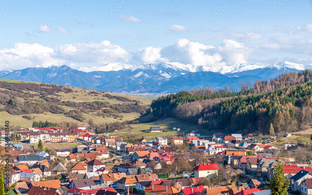 Lucky village, Slovakia, Europe. Aerial view, Tatra mountains, cloudy sky and forest. Sunny spring day.