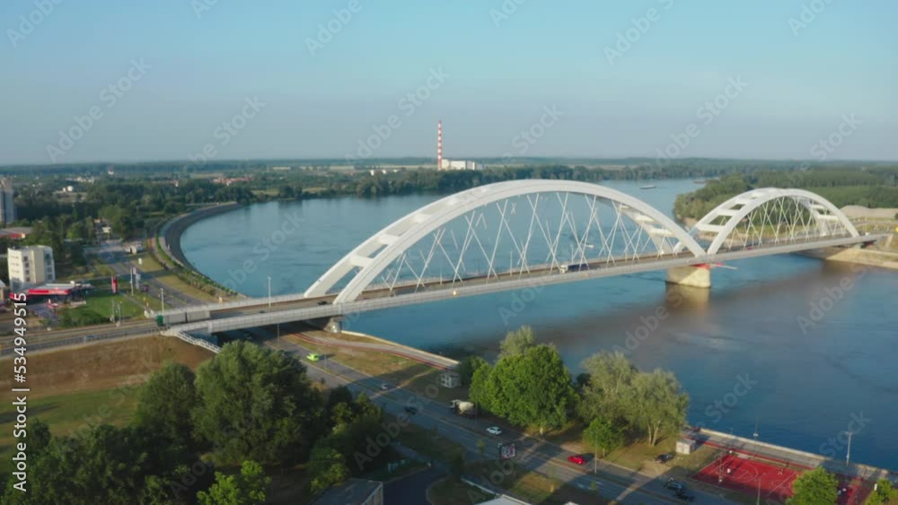 Drone aerial view of zezelj bridge above danube river, Novi Sad, Serbia. Modern city landmark on sunny summer day, Cityscape in skyline Drone aerial view of zezelj bridge above danube river, Novi Sad, Serbia. Modern city landmark on sunny summer day, Cityscape in skyline