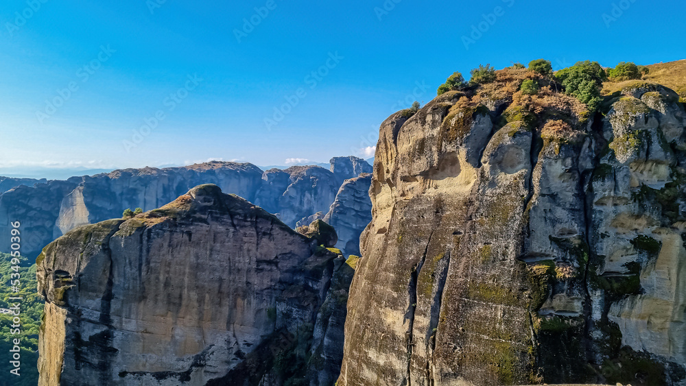 Panoramic view of steep canyons of rock formations of the complexes of Eastern Orthodox monasteries in Kalambaka, Meteora, Thessaly, Greece, Europe. unique cliffs and dramatic landscape, freedom vibes