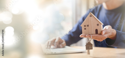 Men holding house model in hand and calculating financial chart for investment to buying property. 