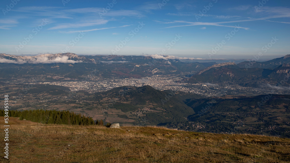 Valley with the city of Grenoble seen from the mountains of Chamrousse in summer in the Alps in France Valley with the city of Grenoble seen from the mountains of Chamrousse in summer in the Alps in France