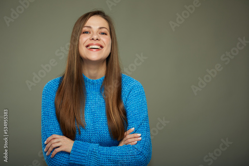 Smiling beautiful woman in blue warm knitted sweater. Isolated female portrait.