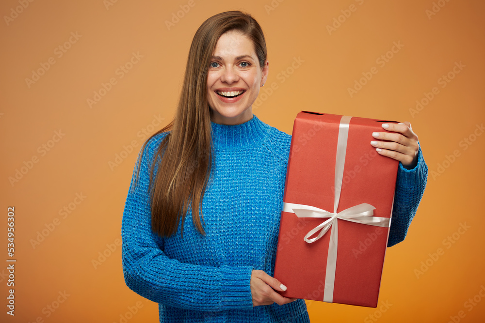 Happy woman with big red gift box. Isolated portrait on orange background. Happy woman with big red gift box. Isolated portrait on orange background.