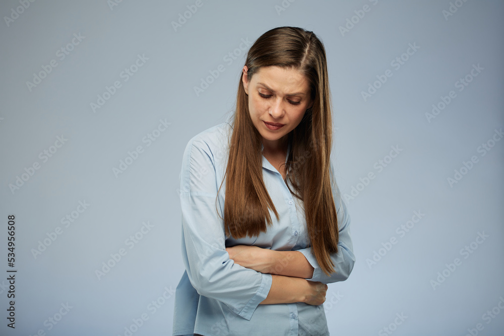 Woman with stomach pain looking down. isolated portrait. Woman with stomach pain looking down. isolated portrait.