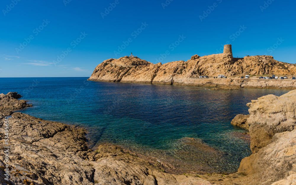 The old lighthouse and the Genoese tower on the rocky Pietra peninsula in the L'Île-Rousse commune of France on Corsica Island 