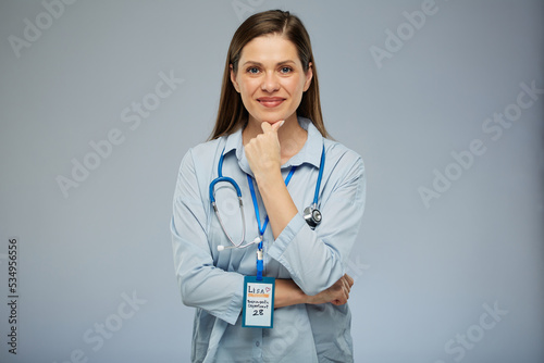 Thinking smiling doctor woman Isolated portrait on blue background.