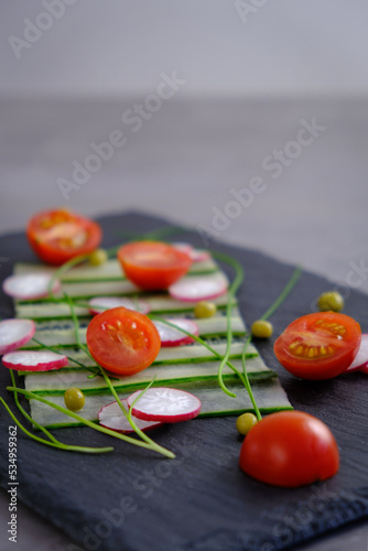 tomato, radish  and cucumber salade on the black plate (ID: 534959362)