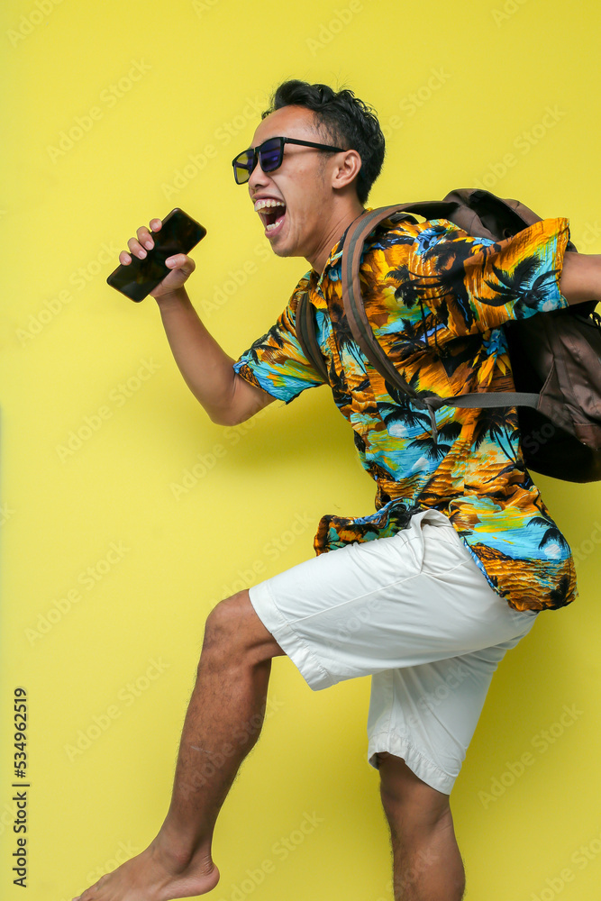 a man wearing a beach shirt and white pants a man wearing a beach shirt and white pants