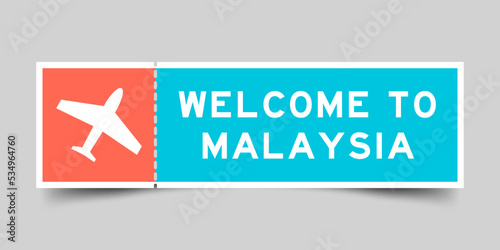 Orange and blue color ticket with plane icon and word welcome to malaysia on gray background