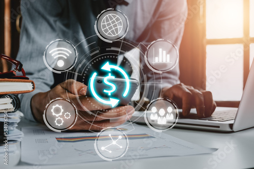 SWIFT. Society for Worldwide Interbank Financial Telecommunications, Businessman using smartphone with VR screen swift icon on office desk, Financial Banking regulation concept. photo