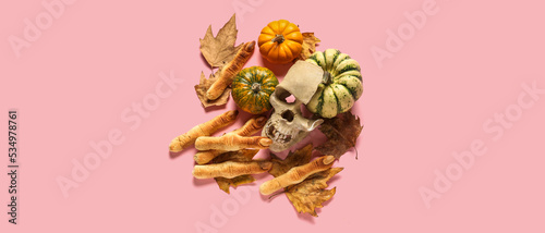 Halloween cookies with human skull  pumpkins and autumn leaves on pink background