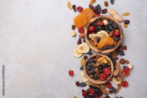 Wooden bowls with raisins, nuts and other dried fruit, berries as ingredient for tasty dessert
