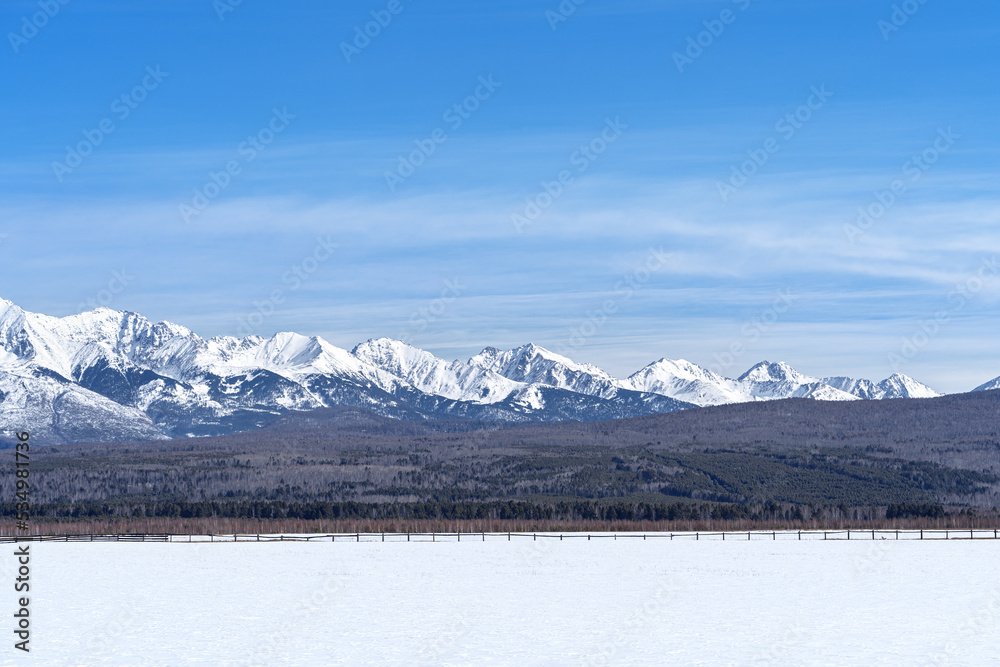 Winter landscape with Sayan Mountains in Siberia on sunny winter day. Natural background.