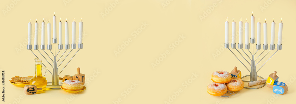Menorah, traditional treats for Hanukkah and dreidels on beige background with space for text Menorah, traditional treats for Hanukkah and dreidels on beige background with space for text