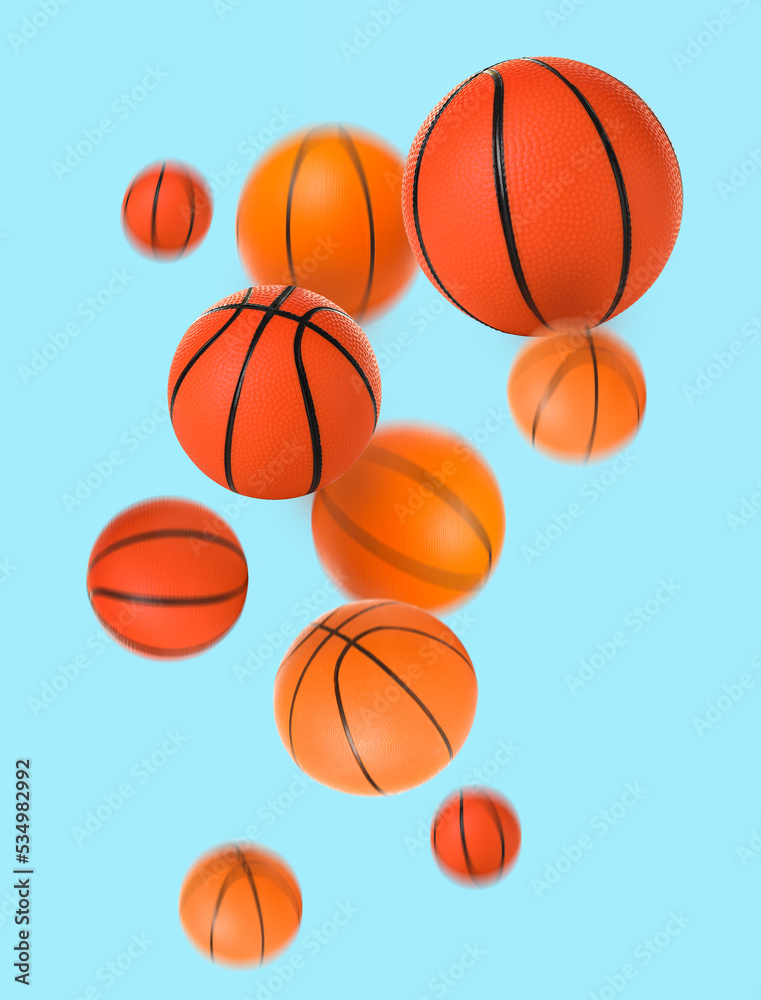 Flying basketball balls on light blue background