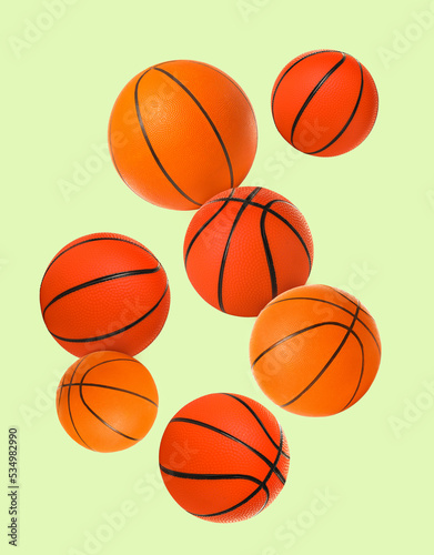 Flying basketball balls on green background