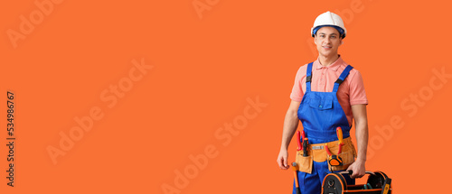 Young electrician with tool...