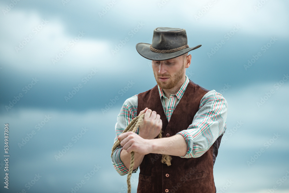 Cowboy farmer man in country side wearing western cowboy hat. American ...
