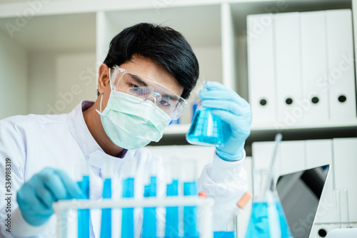Close-up male scientist, laboratory specialist working with test tubes scientist. Chemist. Science technology concept. Chemistry and medical science research study concepts. Medical Research