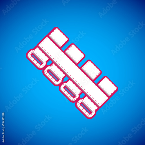 White Hunting cartridge belt with cartridges icon isolated on blue background. Bandolier sign. Hunter equipment, armament. Vector
