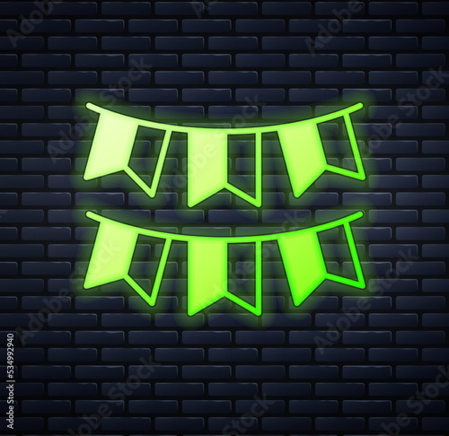 Glowing neon Carnival garland with flags icon isolated on brick wall background. Party pennants for birthday celebration, festival decoration. Vector