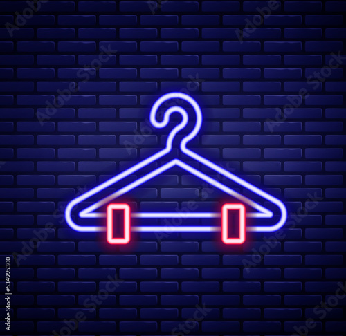 Glowing neon line Hanger wardrobe icon isolated on brick wall background. Cloakroom icon. Clothes service symbol. Laundry hanger sign. Colorful outline concept. Vector