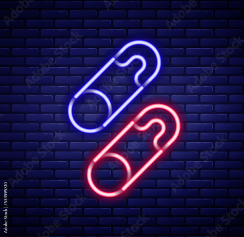 Glowing neon line Classic closed steel safety pin icon isolated on brick wall background. Colorful outline concept. Vector