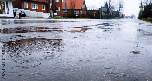 Rain pouring down in a Danish city making the streets wet