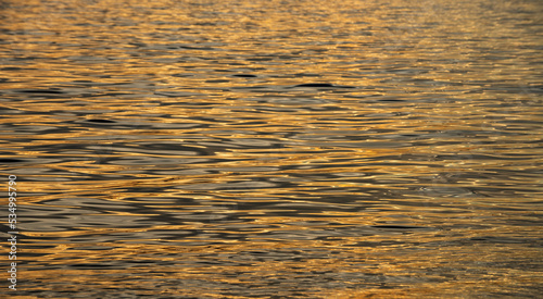 Seascape on sunrise over sea. Nature landscape. Sunrise sea water background. Reflection of sun in the ocean water. Calm ocean and sky background.