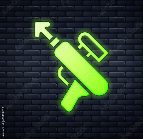 Glowing neon Fishing harpoon icon isolated on brick wall background. Fishery manufacturers for catching fish under water. Diving underwater equipment. Vector