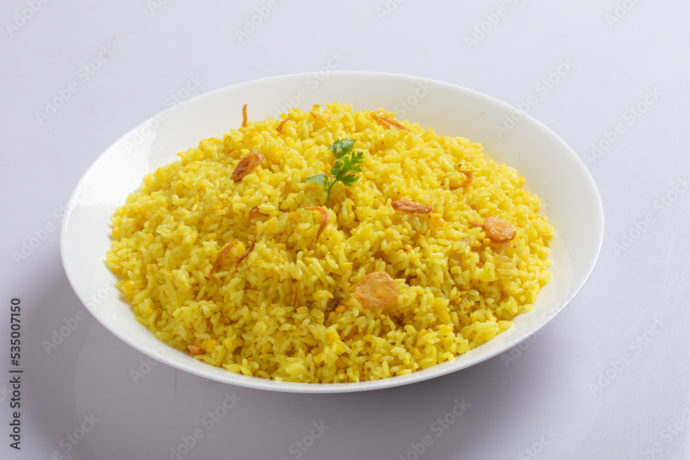Bengali dish khichdi or khichuri made from a combination of lentils and rice along with Indian spices. in a mud bowl isolated on white background Bengali dish khichdi or khichuri. Bengali dish khichdi or khichuri made from a combination of lentils and rice along with Indian spices. in a mud bowl isolated on white background Bengali dish khichdi or khichuri.