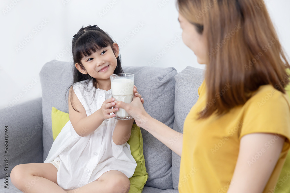 Mother Give a Glass of Milk to Her Daughter for Breakfast Mother Give a Glass of Milk to Her Daughter for Breakfast