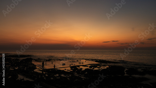 Sunset swimmers, on a beautiful evening in August. Enjoying the seawater pool at Westward Ho .
