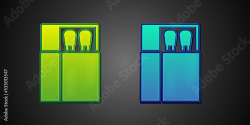 Green and blue Open matchbox and matches icon isolated on black background. Vector
